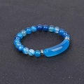 Macro view of blue agate stone beads and silver metal tube on a polished stone bracelet - Striped Blue Agate
