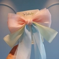 Close-up of the pastel gradient organza oversized bow hair clip with luxury texture - Pink Yellow Blue Gradient