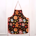 Christmas apron with festive gingerbread and star prints on a black fabric background - Gingerbread Man