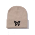 Close-up of khaki knit beanie featuring detailed black butterfly embroidery on the cuff - One Size / Khaki