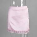 Nahaufnahme von rosa Satin-Minirock mit zartem floralem Spitzenbesatz am Saum - S / Rosa