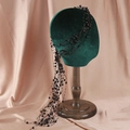 Elegant black beaded bridal hair net with long tassels on a velvet display head - Black