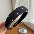 Detailed close-up of handmade wide padded satin headband with white polka dot patterns - Black