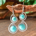 Detail of silver bohemian teardrop earrings with turquoise stones hanging on a wooden branch - Double Layer Round Stone (HQEF-0348)