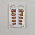 Detail of almond press-on nails featuring tiger stripes and floral 3D accents in box - 24 Pieces Per Box / Tiger Stripes with 3D Flowers (WY-027)