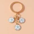 Detail of metal keychain with three mini blue and white enamel soccer ball charms - Blue