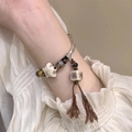 Bracelet multicouche bohème avec perles vintage, breloque céramique et glands bruns - Style Céramique Nouveau Chinois