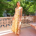 Close-up of floral print maxi dress with spaghetti straps and flowing hem design - S / Yellow Floral