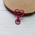 Macro shot of bright pink heart-shaped metal lobster clasp for jewelry making - Rose Red