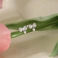 Silver bow stud earrings with heart pendants displayed on fresh tulip stems - Butterfly Bow Heart Pendant (A122)