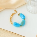 Golden chain bracelet with three irregular bright blue stones and a circular charm - Stainless Steel Marble Pattern Bracelet / Blue