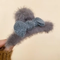 Detail of plush grey faux fur hair claw clip featuring a soft bowknot for women - Gray