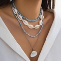 Bohemian multi-layer beaded necklace with white shells and blue beads on a model - White K (4439)