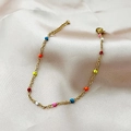 Golden chain bracelet with colorful beads and lobster clasp on satin fabric - Gold Multicolor