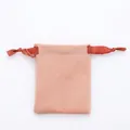 Close-up of a soft pink velvet jewelry drawstring pouch with orange silk ribbons - 8*10cm / Light Pink