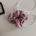 Detail of pink satin scrunchie with delicate white ribbon ties on a white background - Pink