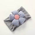 Close-up of grey cable knit baby headband with a soft light blue fabric flower detail - Gray