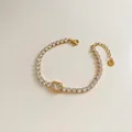 Gold-finished tennis bracelet featuring a large emerald-cut zircon and lobster clasp - Stainless Steel/Zirconia / Gold Rectangular Main Stone Style (SBK401)