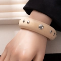 Detail of wide wooden cuff bracelet featuring embedded silver metal hemisphere studs - Style L365-4 Natural Wood Mixed Size Studs