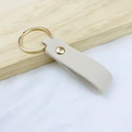 Minimalist beige PU leather keychain with polished gold metal ring and rivet detail - No.13 Ivory