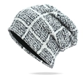Detailed close-up of chunky knit texture and classic black and white checkered pattern beanie - Navy Blue