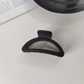 Close-up of a sleek matte black shark hair claw clip with a professional curved design - Black Semi-Circle Claw Clip
