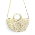 Detail of straw woven bucket bag with circular handle and braided shoulder strap - Integrated Strap Style / Medium / Off White