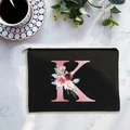 Black canvas cosmetic bag with rose gold letter K and floral print on marble surface - Letter K