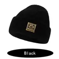 Cozy black knitted beanie for children featuring a stylish golden happy face logo patch - S (6-36 Months) / Black