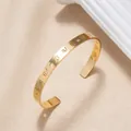 Adjustable golden hollow roman numeral cuff bracelet with leaf-style cutouts - Roman Numerals