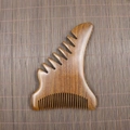 Macro shot of sandalwood massage comb with five thick teeth and fine natural wood grain - Golden Sandalwood Large Monster Shape (13*9.5*1cm)