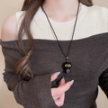 Close-up of cute black cat pendant necklace with red and green beads on woven cord - 34# Necklace-Black