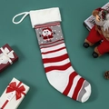 Knitted Christmas stocking with Santa Claus pattern and festive red and white stripes - Santa Claus