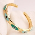 Golden open evil eye cuff bracelet with blue enamel inlay and polished metallic finish - Turquoise Blue Enamel Style (SL99-1)