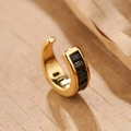 18K gold plated ear cuff with five square black zircons on a natural wood background - Black/Gold