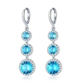 Silver drop earrings with sky blue cubic zirconia stones and halo diamond accents - Earrings / Sky Blue