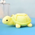 Side view of a soft yellow mini plush sea turtle keychain with shell stitching - Green / 12cm
