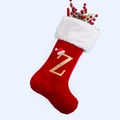 Detail of red velvet Christmas stocking with gold embroidered letter Z and plush white cuff - Letter Z