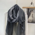 Detail of dark gray wool blend scarf featuring elegant lace patchwork on a gold hanger - Dark Gray