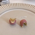 Close-up of pink enamel C-shaped earrings with gold plating on a ceramic tray - Light Jujube Red (Genuine Gold Plated)