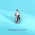 Whale in a bottle enamel pin with blue wave pattern measuring 1.5cm by 3.0cm - Drift Bottle Astronaut