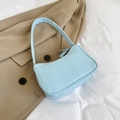 Minimalist light blue faux leather underarm shoulder bag on khaki blazer suit - Blue