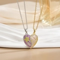 Detail of magnetic heart pendants in gold and silver with BEST FRIEND engraving - Butterfly Flower Heart