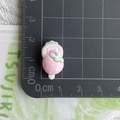 Macro view of pink strawberry resin charm showing scale and small dimensions on cutting mat - Pink Strawberry Popsicle