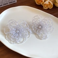 Elegant white ceramic flower cluster stud earrings with central pearl on ceramic dish - Woven Flower / White