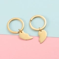 Close-up of polished gold split heart keychains for couples on a dual-color background - Gold Set