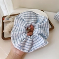 Detail of blue plaid scrunchie featuring delicate light blue bow embroidery patterns - Hair Tie