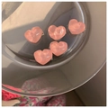 Close-up of five pink heart-shaped hair clips on a glass tray with warm sunset lighting - Water Ripple Heart / 1 Piece (Bulk)