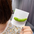 Detail of creative green edamame hair clip with realistic resin texture on a display card - Green Pea
