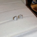 Detail view of silver square stud earrings with white cat eye stone in a jewelry box - Silver Cat's Eye Stone Square Stud Earrings